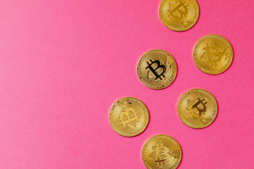 gold round coins on pink surface