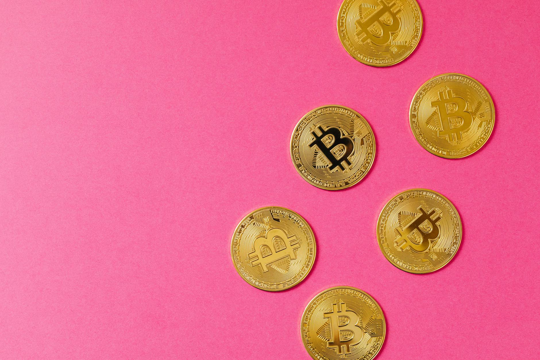 gold round coins on pink surface